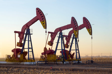  Work of oil pump jack on a oil field. Oil and gas industry. の写真素材