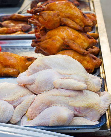 Grilled chicken and fresh chickenの写真素材