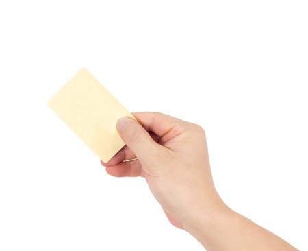 Businessman's hand in a golden holding blank paper business card, closeup isolated over white...