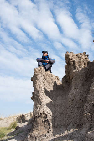 Sitting on a cliff resting hikers. Asian Youthの写真素材