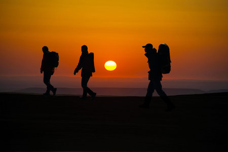 The three hikers walk trip, in the top of the sunrise.