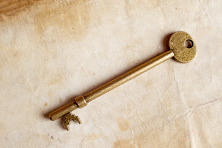 distressed vintage key with old paper texture overlay