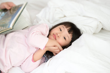 Mom With Children Reading Story in bed