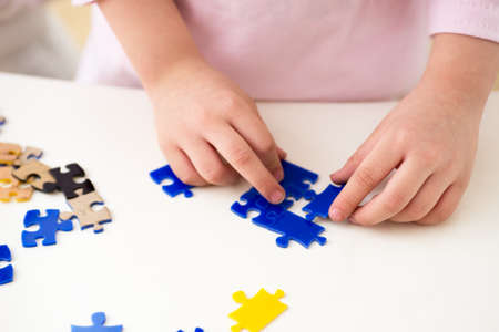 Close-child hand playing with a number puzzleの写真素材