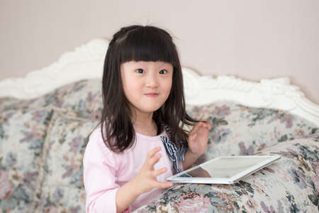 Happy little girl and make weird facial expressions.の写真素材