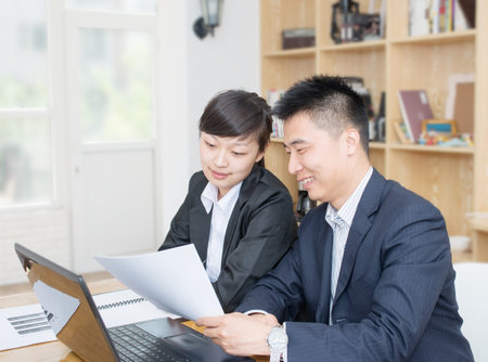 Two business people Having Meeting Around Table In Modern Office