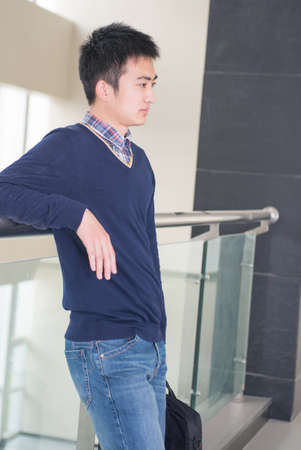 Business men think about standing in office lobbyの写真素材