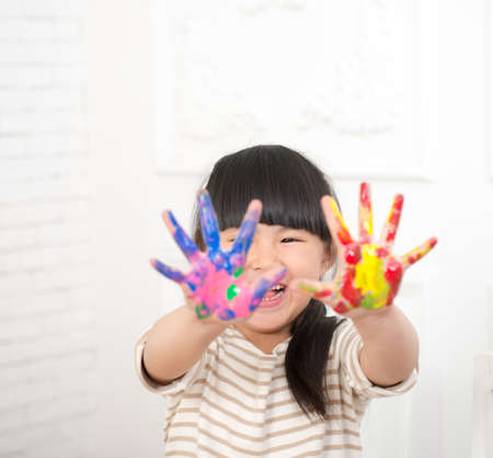 Cute little girl's hand painted watercolor paint colorsの写真素材