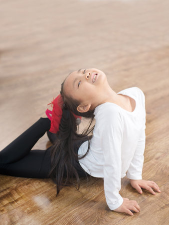 Studio image of a cheerful emotional little girl in a beautiful  is dancingの写真素材