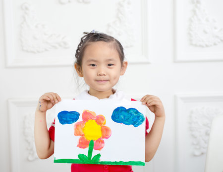 The little girl hands to show their paintingsの写真素材