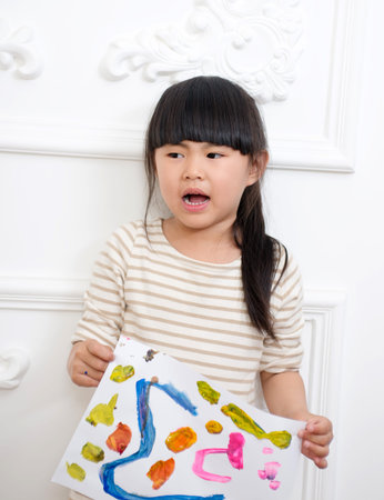 The little girl hands to show their paintingsの写真素材