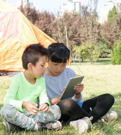 A Girl and A Boy With Tablet Computerの写真素材