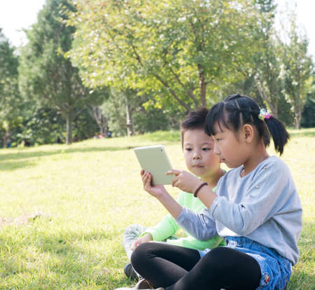 A Girl and A Boy With Tablet Computerの写真素材
