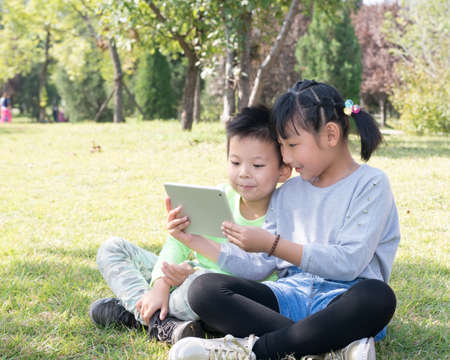 A Girl and A Boy With Tablet Computerの写真素材