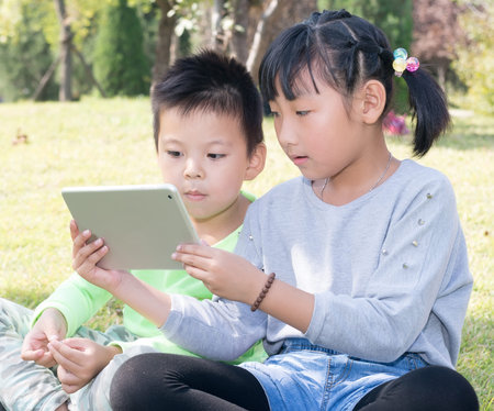 A Girl and A Boy With Tablet Computerの写真素材