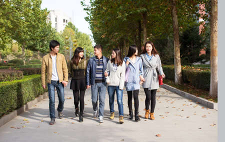 Happy students are taking on school Avenueの写真素材