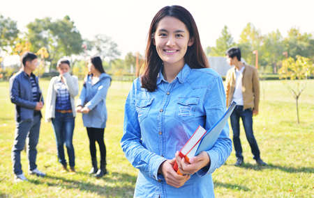 Student girl portrait  outdoor in park smiling happy going back to schoolの写真素材