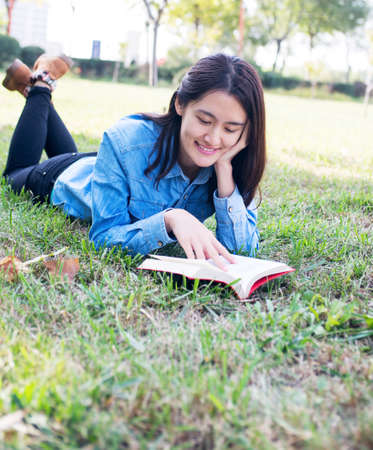 A female college student studying on campusの写真素材