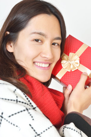 Beautiful woman with a gift. Very pleased withの写真素材