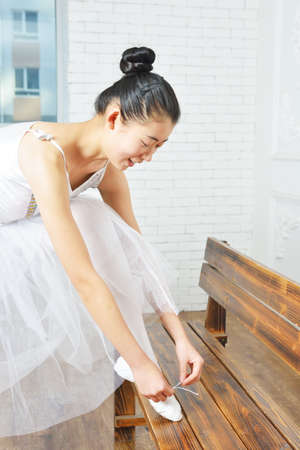 Female ballet dancer elegant lace up one's shoesの写真素材