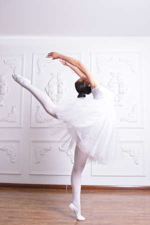 Beautiful female ballet dancer dress rehearsals in the Studioの写真素材