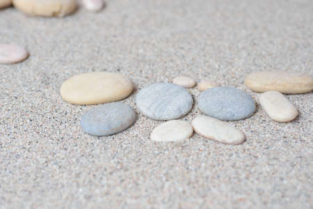 few sand stones on beach sand with a bright backgroundの写真素材