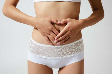 Women put their hands in close-up of the abdomen.の写真素材