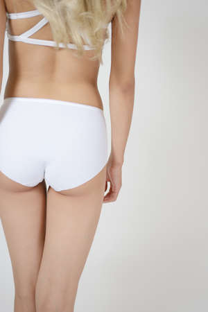 Fitness woman back close-up isolated on white background.の写真素材