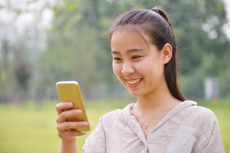 happy girl looking at a mobile phone