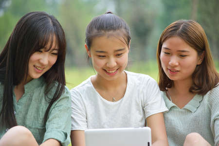 Three women using a tabletの写真素材