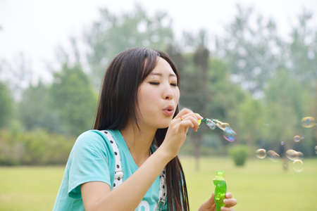 Young woman playing with bubblesの写真素材