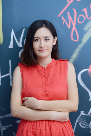This female student standing at the blackboardの写真素材
