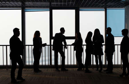 group of people in front of city windowの写真素材