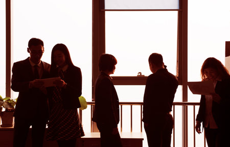 office of the glass window business team sunset silhouette.