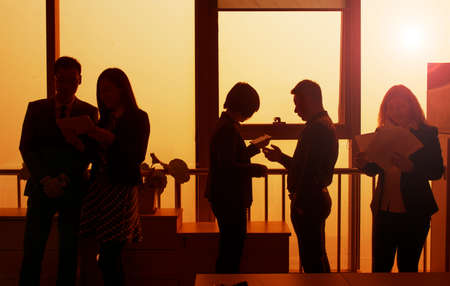 office of the glass window business team sunset silhouette.の写真素材