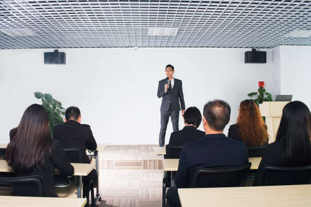 business man giving a conference in a roomの写真素材
