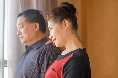 happy retired couple with their heads together in a close embraceの写真素材