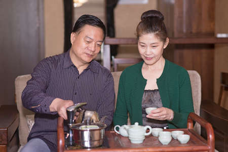 Elderly Couple taste Gongfu  tea  at homeのeditorial素材
