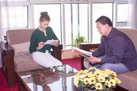 Elderly couples sitting on the sofa with a tablet PCのeditorial素材