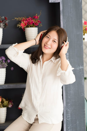 Happy woman with headphones listening to musicの写真素材