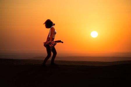 Young woman dancer on outdoor unrise background.の写真素材