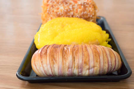 all kinds of bakery products on a wooden desk backgroundの写真素材