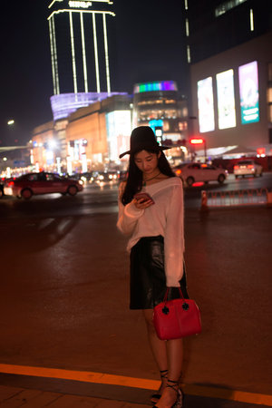 Beautiful woman talking on cellular telephone  at night