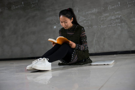 Asian student in a classroom studying.