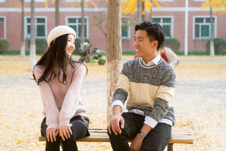 Portrait Of Two Young student. Sitting And Talkingの写真素材