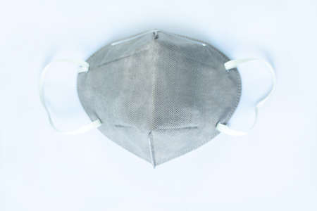 Close-up of a grey N95 mask isolated on a white background.の写真素材