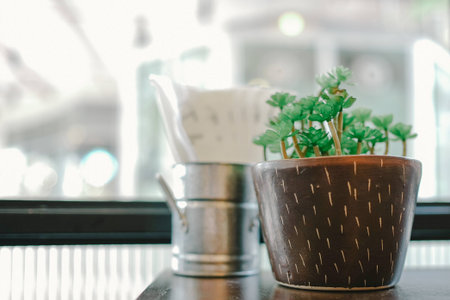 Pot of plastic plant on the tableの写真素材
