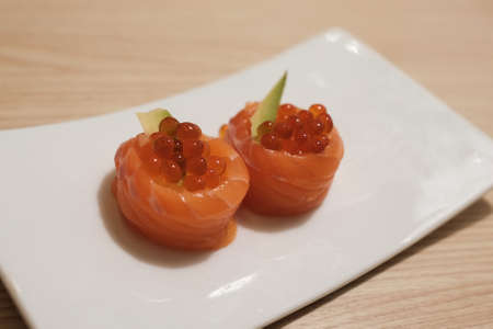 Salmon Ikura Salmon eggs and avocado wrapped with raw salmonの写真素材