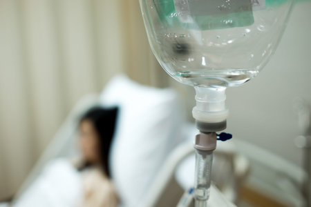 Saline IV drip bottle provided to the patient girl on the background