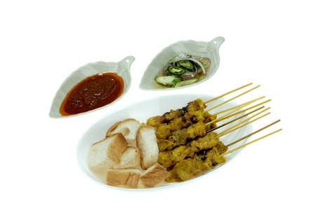 Grilled marinated pork satay with sweet and sour sauce and peanut sauce, isolated on white backgroundの写真素材